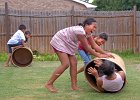 Barrel Fun 5 copy  Cousins (from left to right foreground) Chelsea Chan, 10, Breanna Chan, 11, and Felicity Chan, 11 (in barrel), play with barrels in the yard of their grandfather&#39;s home in Glendale, Tuesday afternoon, 7-17-07. In left background are Malachi Chan, 7, and Corey Chan, 6.